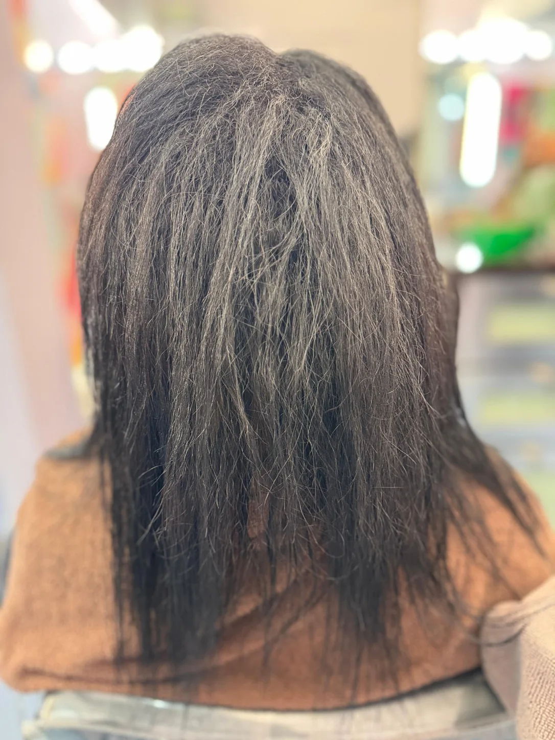 Before anti-frizz smoothing treatment: dark shoulder-length hair that is dry, frizzy and unruly, at Beyond Salon in Condado, San Juan