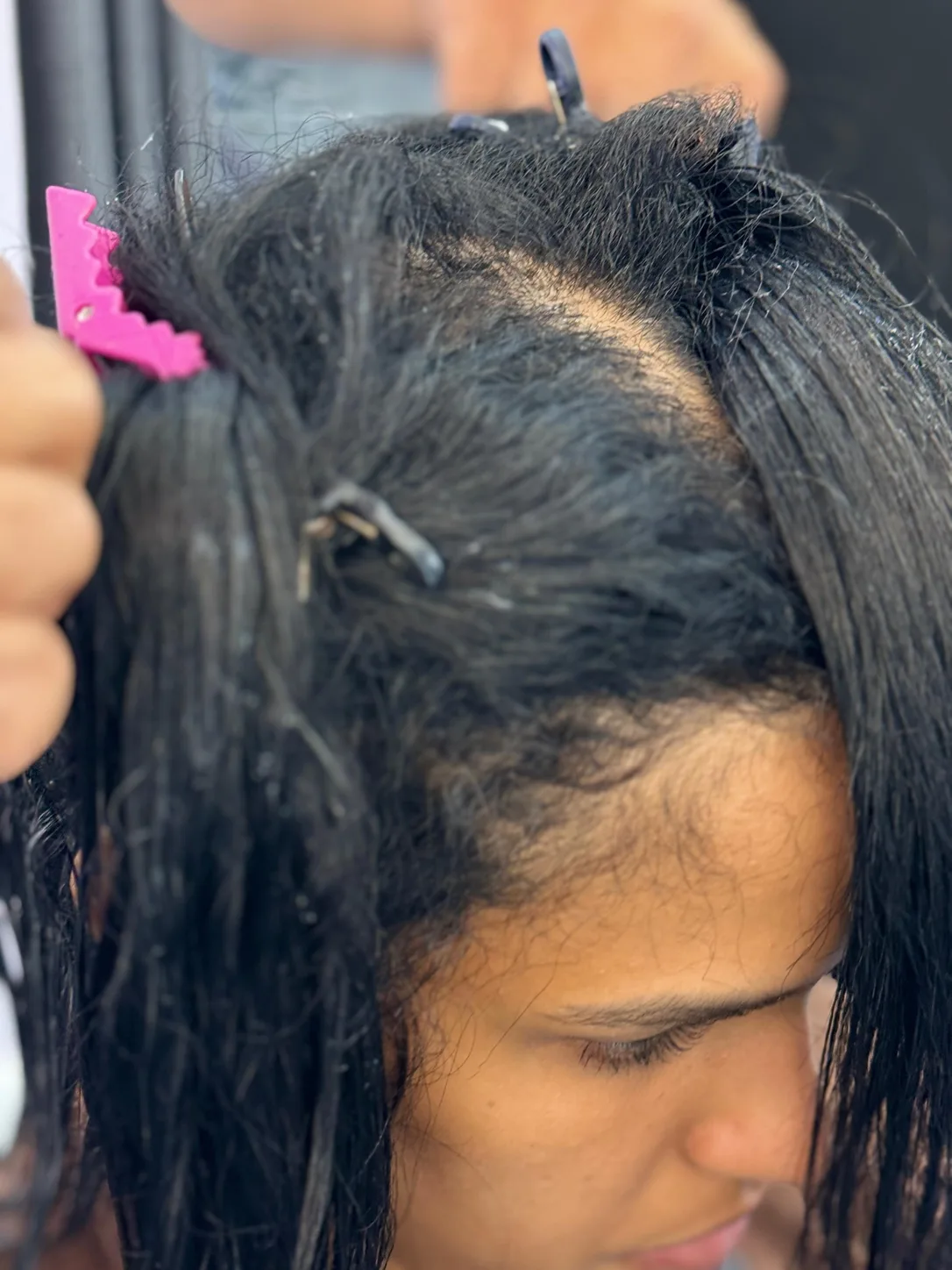 During an anti-frizz smoothing treatment: hair divided into clipped sections, front view, at Beyond Salon in Condado